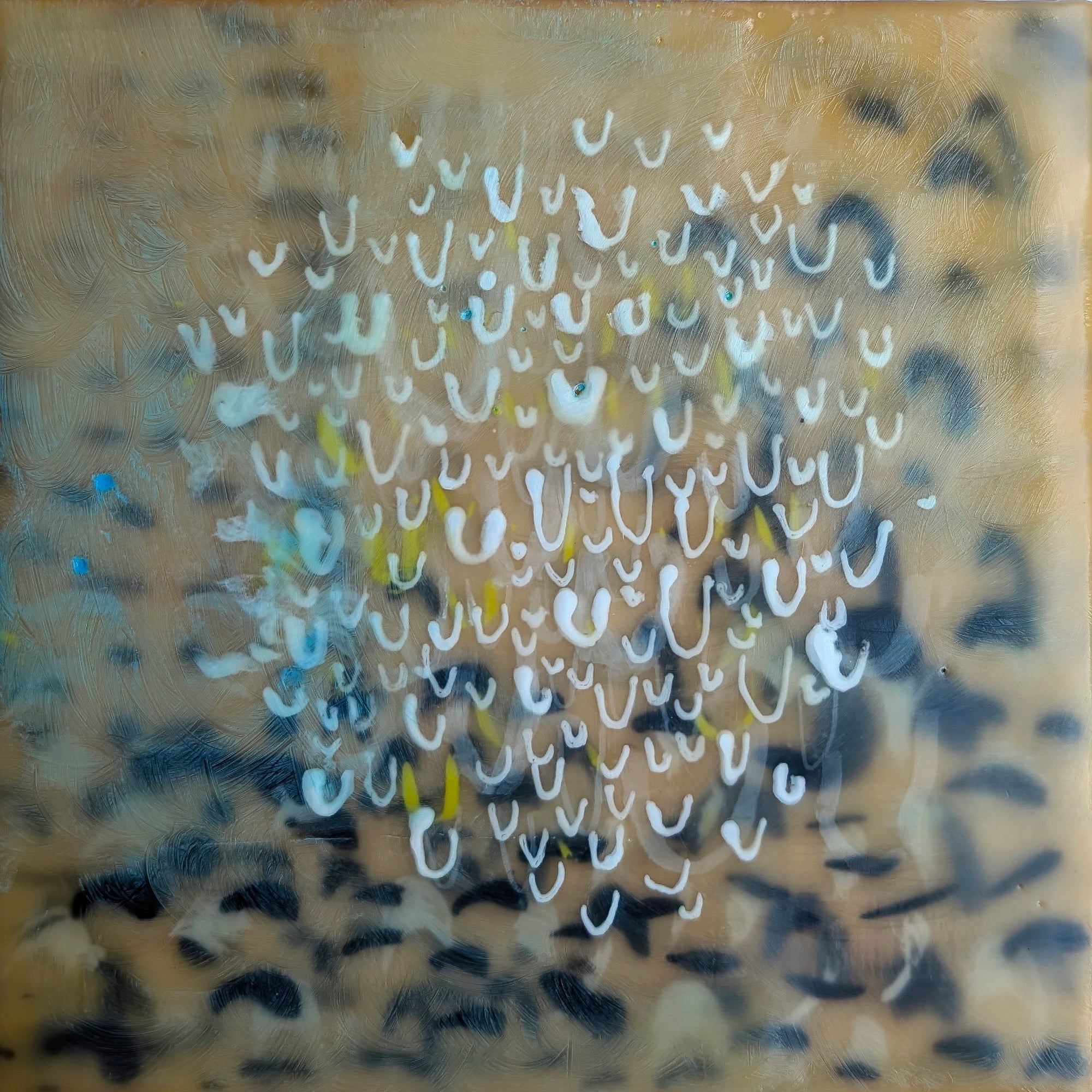 Encaustic painting on wood that shows a mass of white floating marks against black marks 